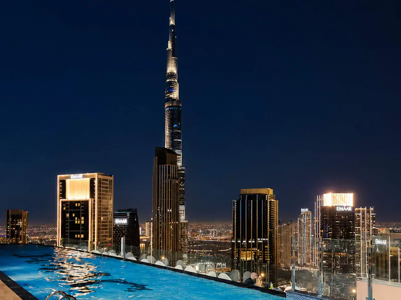 Rooftop pool at night with Burj Khalifa lit up